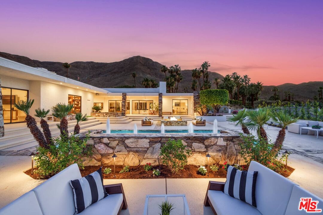 70255 Thunderbird Road Rancho Mirage, CA 92270 - Photo 2 of 53 a view of a patio with couches table and chairs potted plants and a large tree