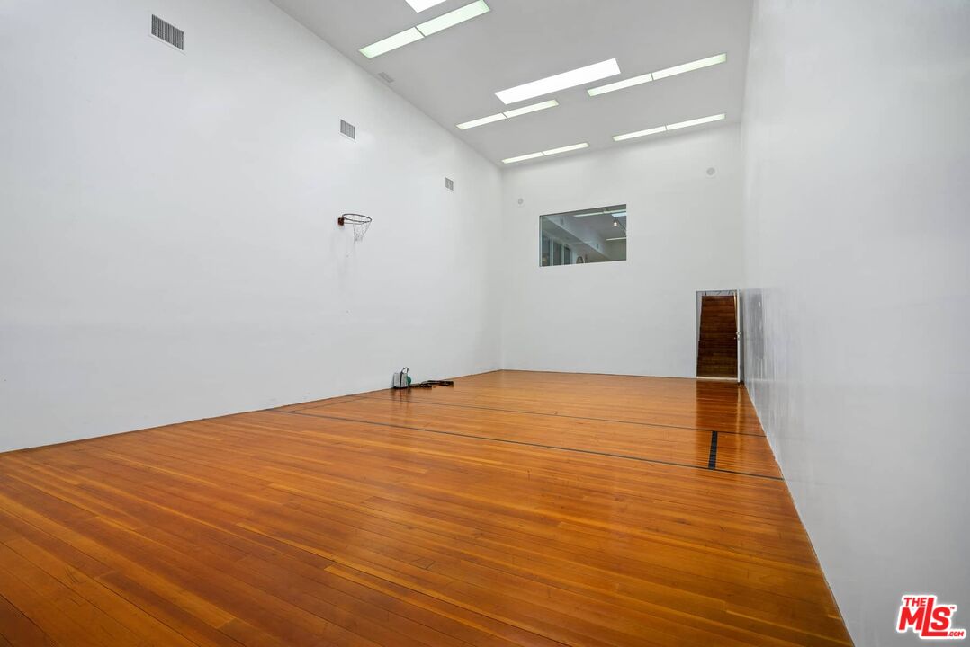 70255 Thunderbird Road Rancho Mirage, CA 92270 - Photo 29 of 53 an empty room with wooden floor and windows
