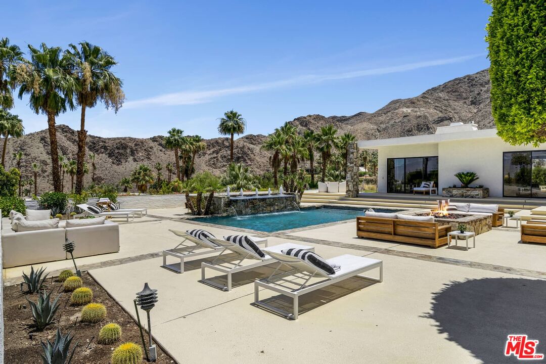 70255 Thunderbird Road Rancho Mirage, CA 92270 - Photo 6 of 53 a view of a swimming pool with lounge chairs