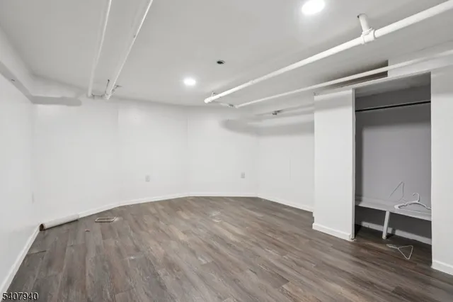 a large kitchen with sink refrigerator and cabinets