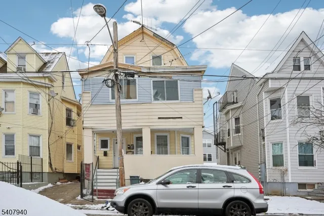 a front view of a residential apartment building with a parking space