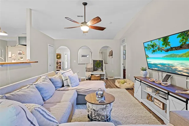 a living room with a couch and chandelier