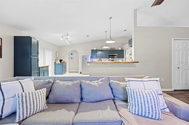 a kitchen with stainless steel appliances granite countertop a refrigerator a sink dishwasher a oven with a dining table and chairs