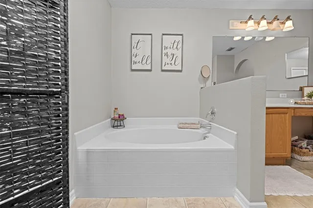 a bedroom with a bed and a large mirror