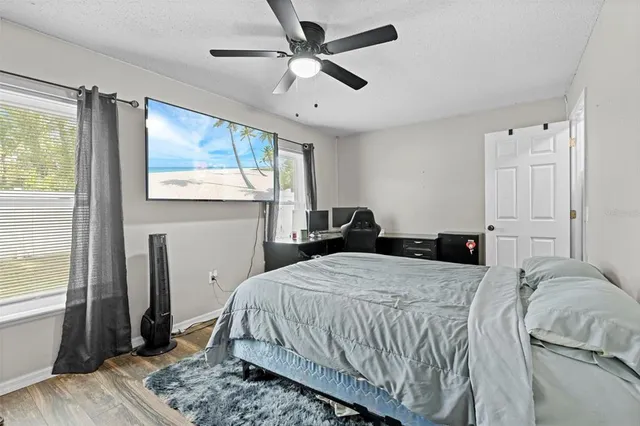 a bedroom with a bed and a chandelier