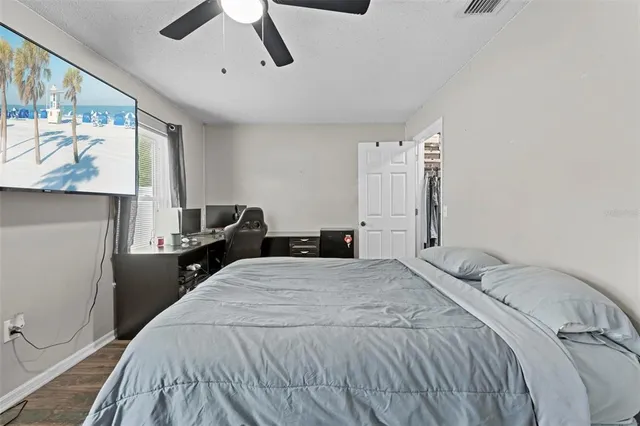 a bedroom with a bed and a desk