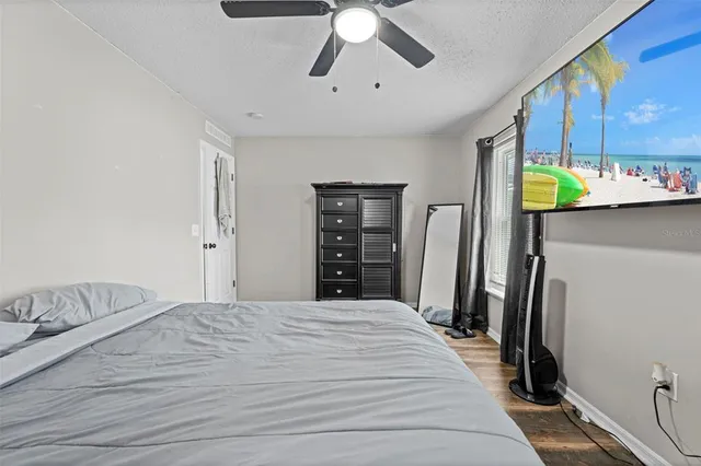 a bedroom with a bed and a large mirror