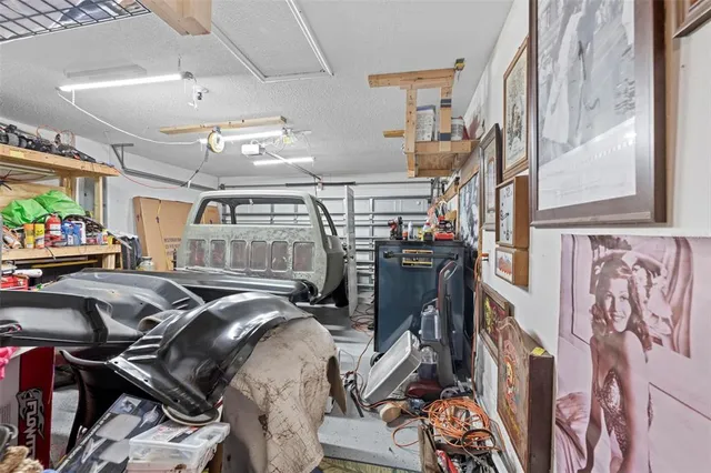 a view of a backyard with table and chairs and a large tree