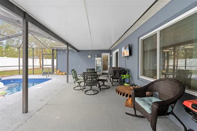an aerial view of a residential houses with yard