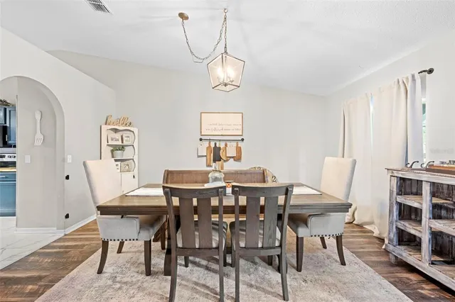 a spacious bedroom with a bed and a chandelier