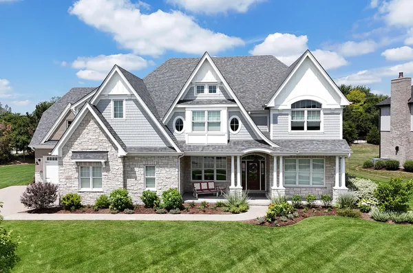 a front view of a house with a yard and porch