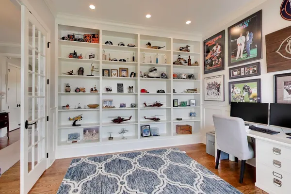 a spacious bedroom with a bed and a flat screen tv