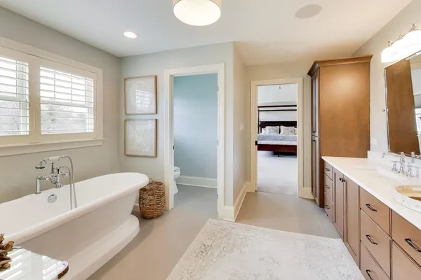 a spacious bedroom with a bed and a chandelier