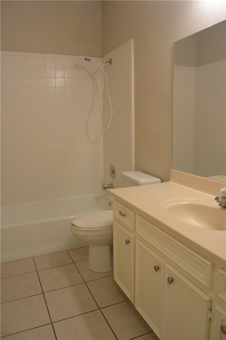 4902 Smokey Valley, Unit A Austin, TX 78731 - Photo 14 of 19 Bath downstairs with tile floors that has access from hallway and adjacent bedroom.