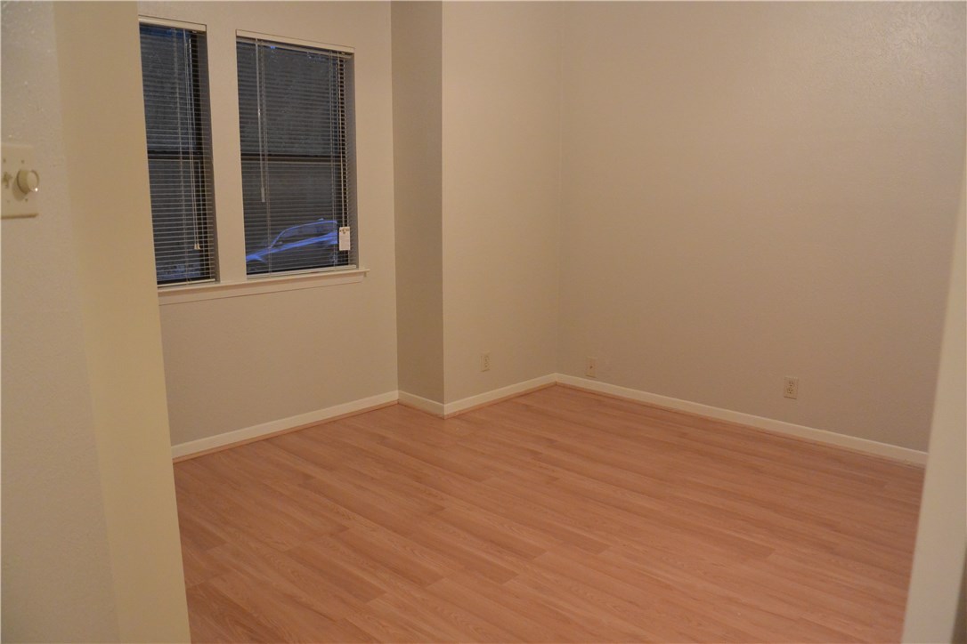 4902 Smokey Valley, Unit A Austin, TX 78731 - Photo 15 of 19 Downstairs bedroom with closet on left and bathroom entrance on right.