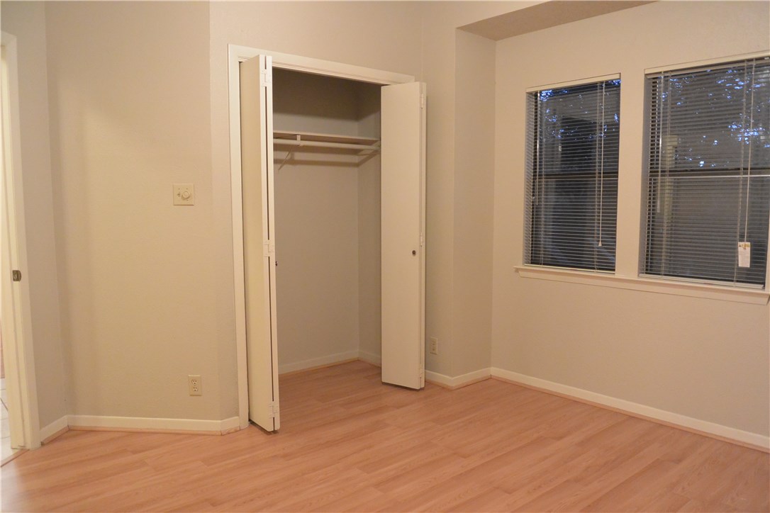 4902 Smokey Valley, Unit A Austin, TX 78731 - Photo 16 of 19 Downstairs bedroom with entrance on left. Window overlooks front yard.