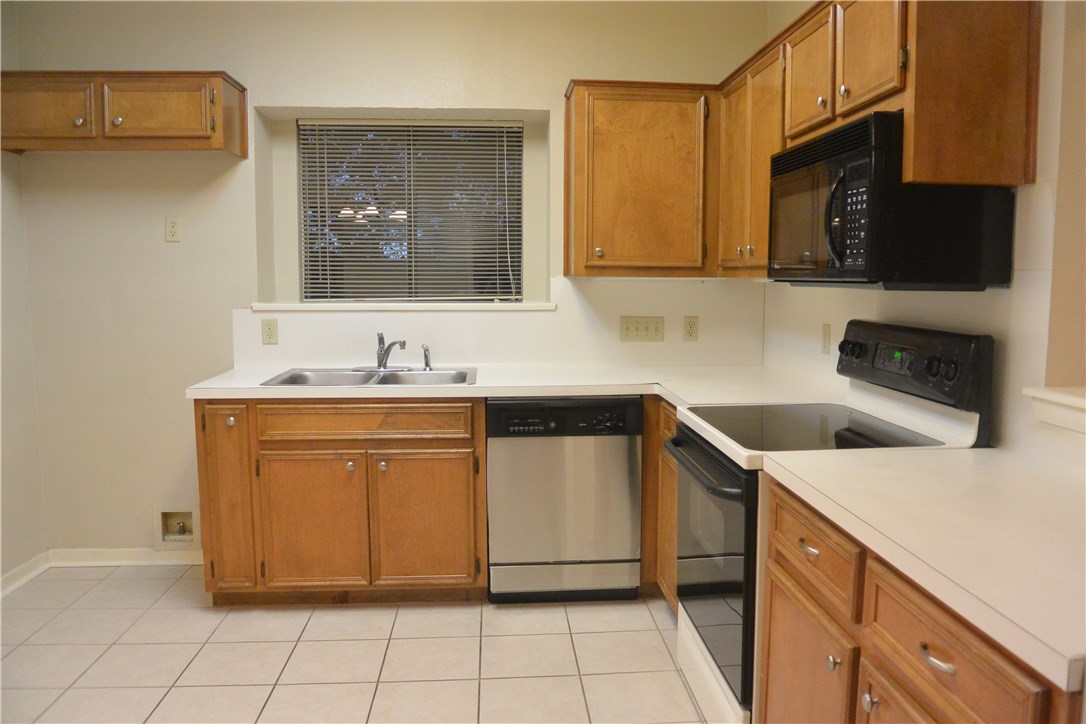 4902 Smokey Valley, Unit A Austin, TX 78731 - Photo 4 of 19 Kitchen with microwave and tile floors. Refrigerator not pictured.