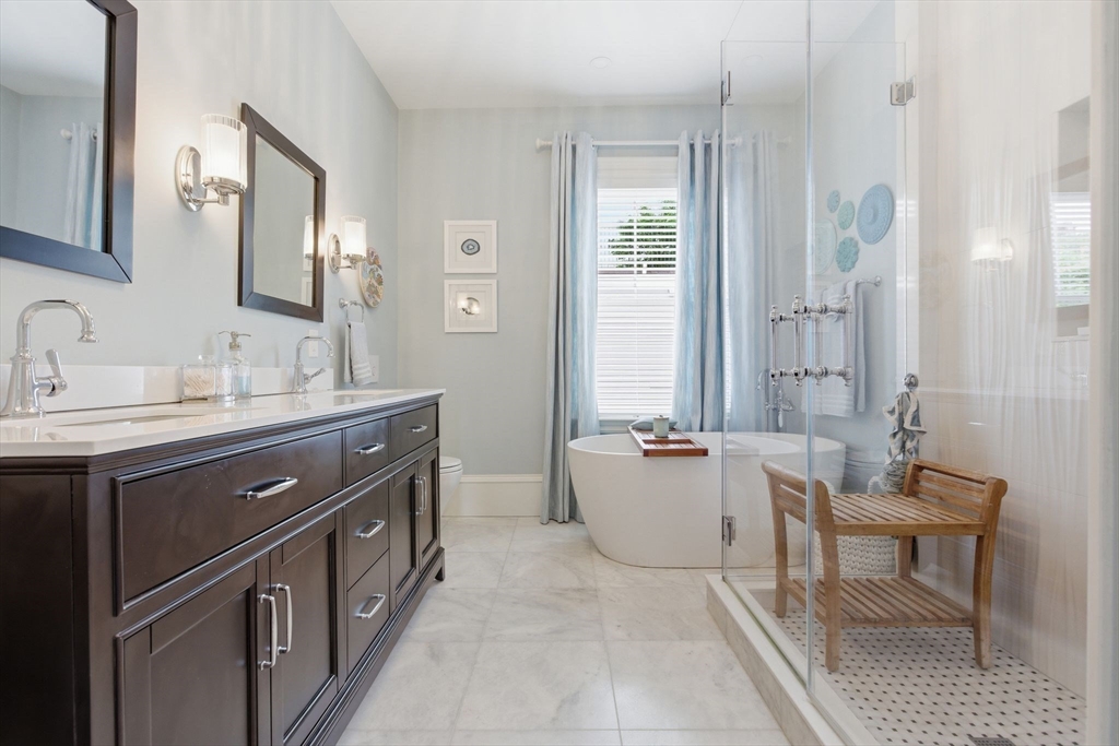 419 Main Street Boston, MA 02129 - Photo 25 of 41 a spacious bathroom with a double vanity sink a mirror and a bathtub