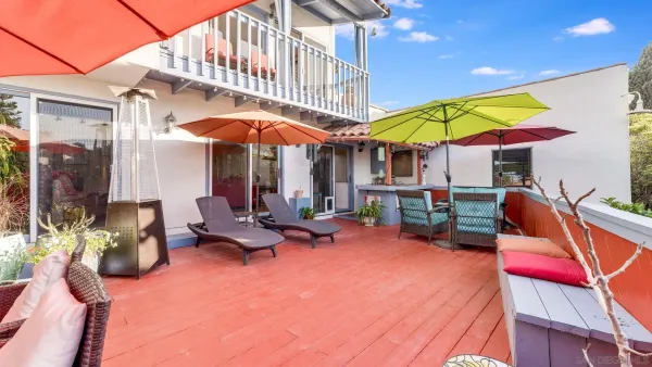 a view of the a tables and chairs under an umbrella in the patio