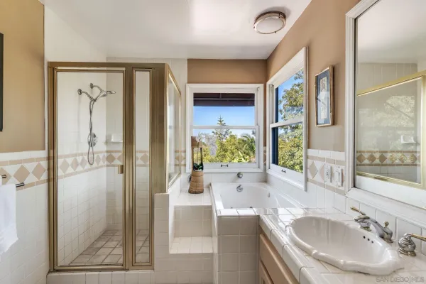 a bathroom with a tub sink and mirror