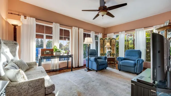 a living room with furniture a rug and a painting on the wall