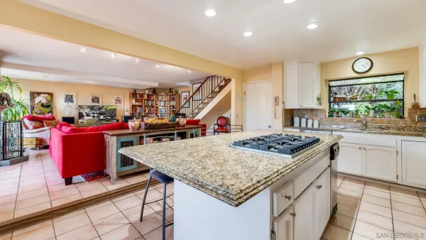 a kitchen that has a table and chairs in it