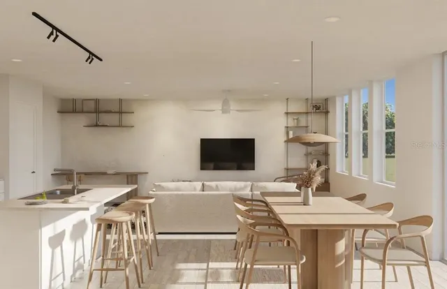 a kitchen with a table chairs a sink dishwasher and cabinets
