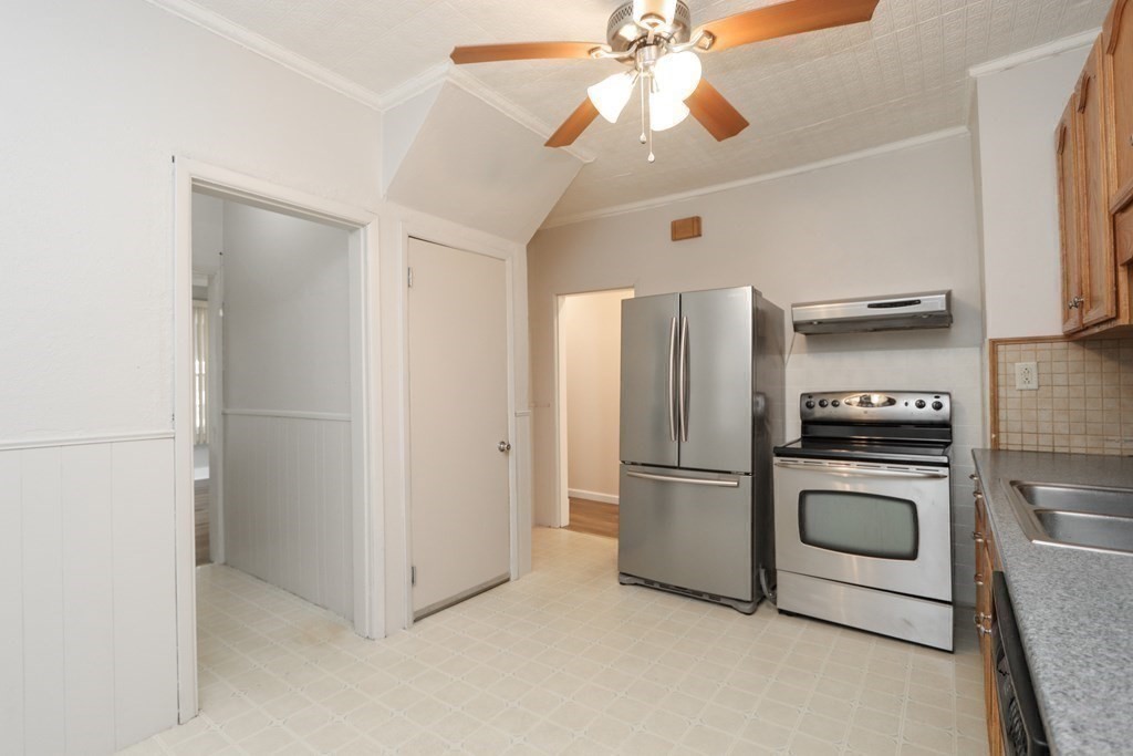 46 Osborne Terrace Springfield, MA 01104 - Photo 11 of 42 a kitchen with stainless steel appliances a refrigerator and a chandelier