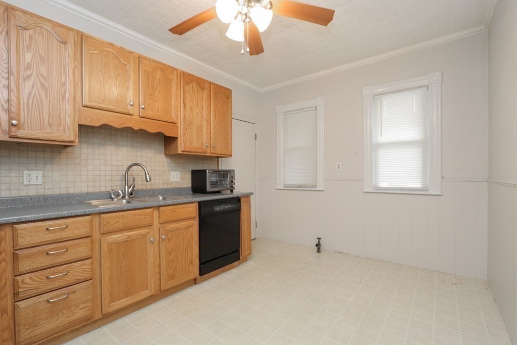 46 Osborne Terrace Springfield, MA 01104 - Photo 12 of 42 a kitchen with granite countertop white cabinets and stainless steel appliances