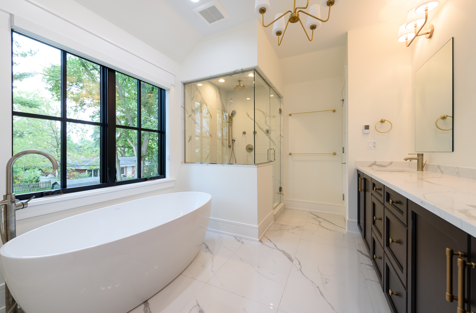 1031 Prairie Lawn Road Glenview, IL 60025 - Photo 11 of 11 a spacious bathroom with a tub sink and mirror