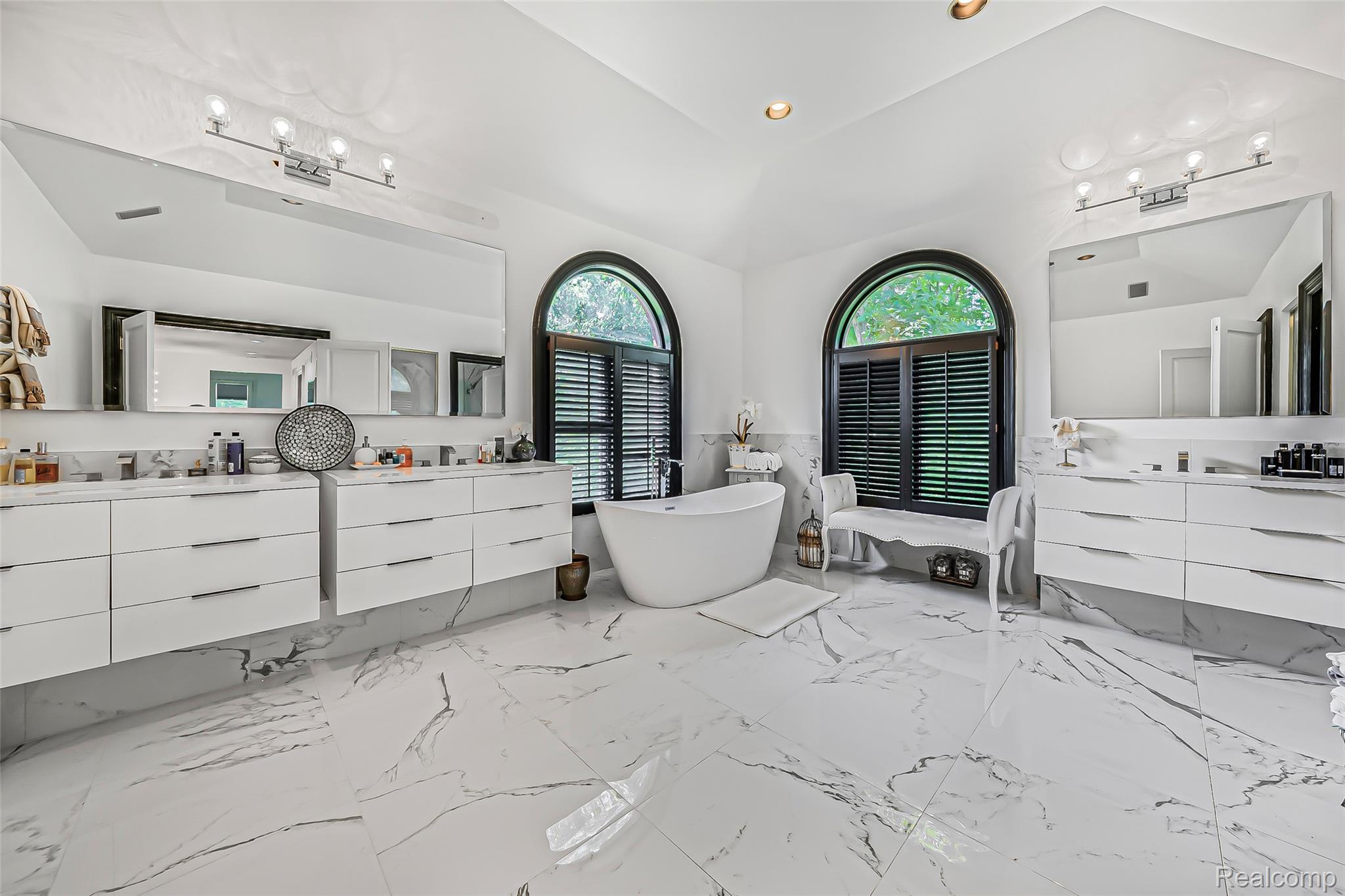 2785 Cranbrook Ridge Court Rochester, MI 48306 - Photo 39 of 99 Freestanding soaking tub, dual floating vanities with ample storage, large format floor tiles, and dual arched windows with plantation shutters