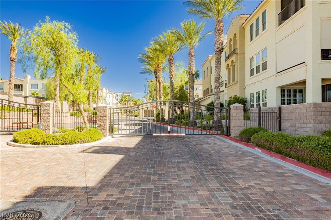 2555 Hampton Road, Unit 3308 Henderson, NV 89052 - Photo 57 of 65 Palm-lined drive leads to this gated community with Mediterranean-inspired architecture.