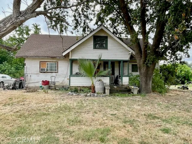 a view of backyard with barbeque grill and wooden fence