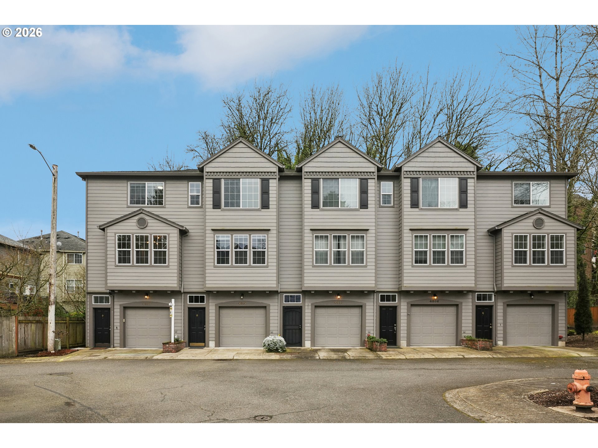 4818 Southwest 2nd Court Portland, OR 97239 - Photo 1 of 26 a front view of a residential apartment building with a yard