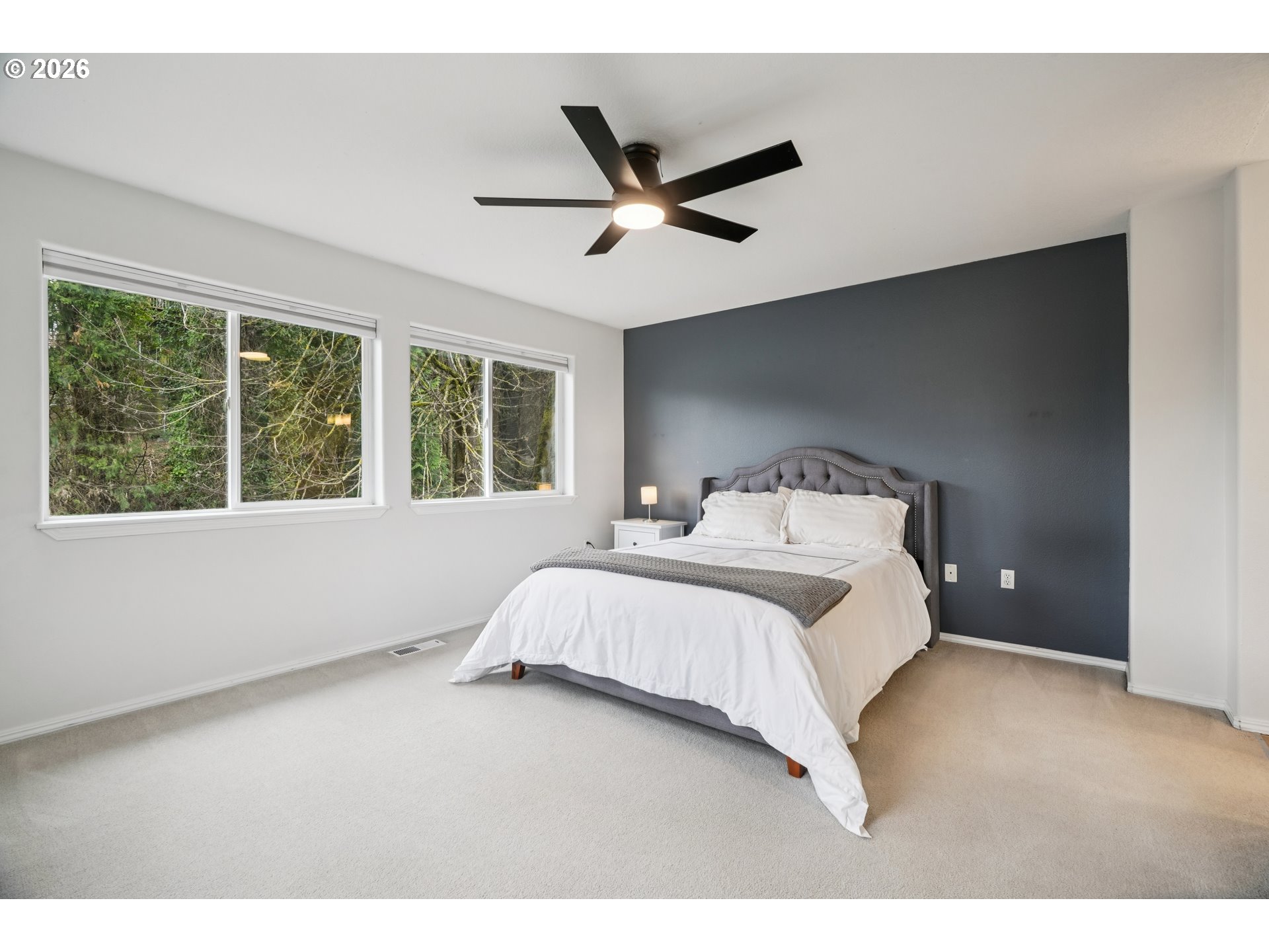4818 Southwest 2nd Court Portland, OR 97239 - Photo 13 of 26 a bedroom with a large bed and a large window