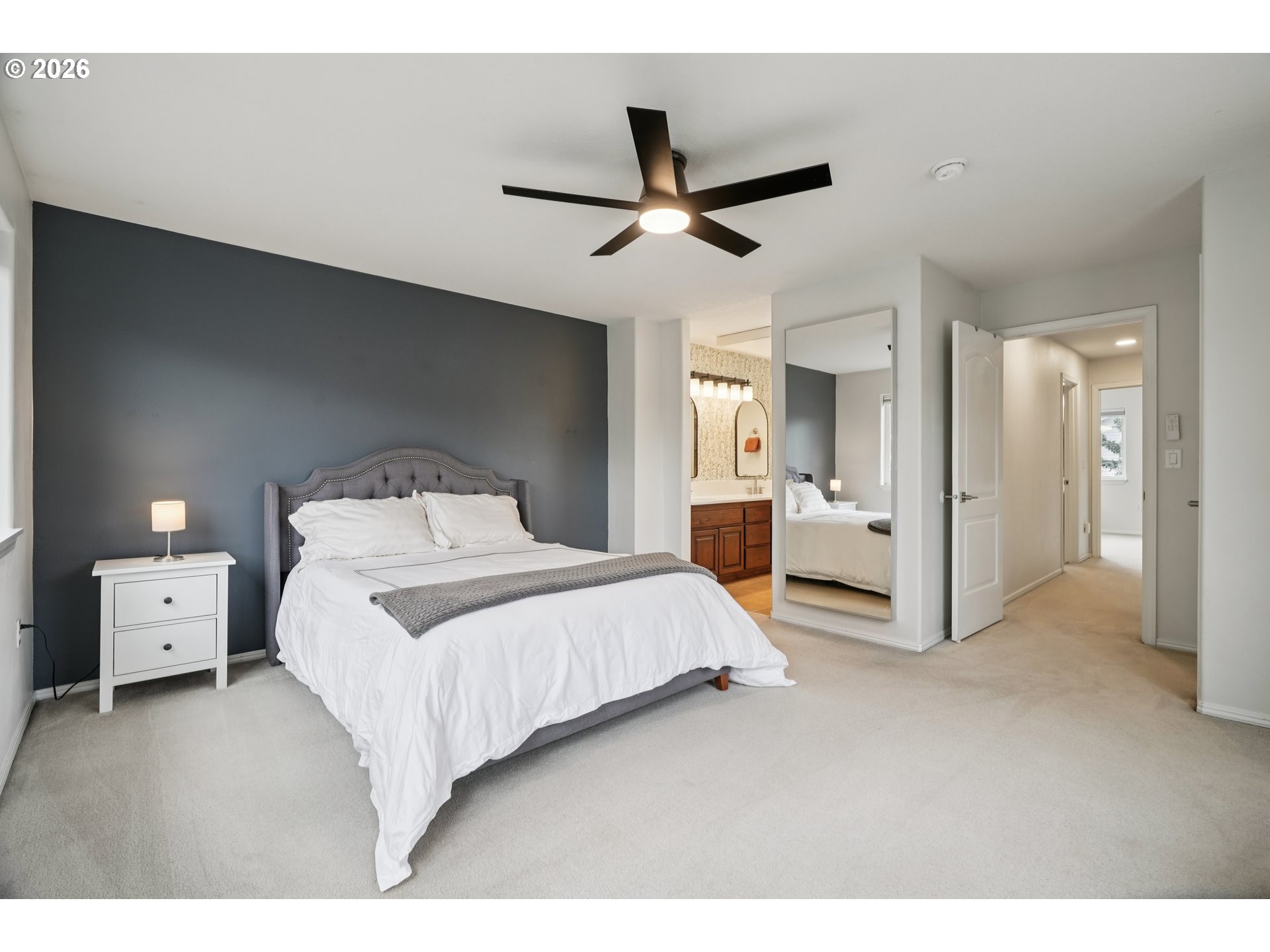 4818 Southwest 2nd Court Portland, OR 97239 - Photo 14 of 26 a bedroom with a large bed and ceiling fan