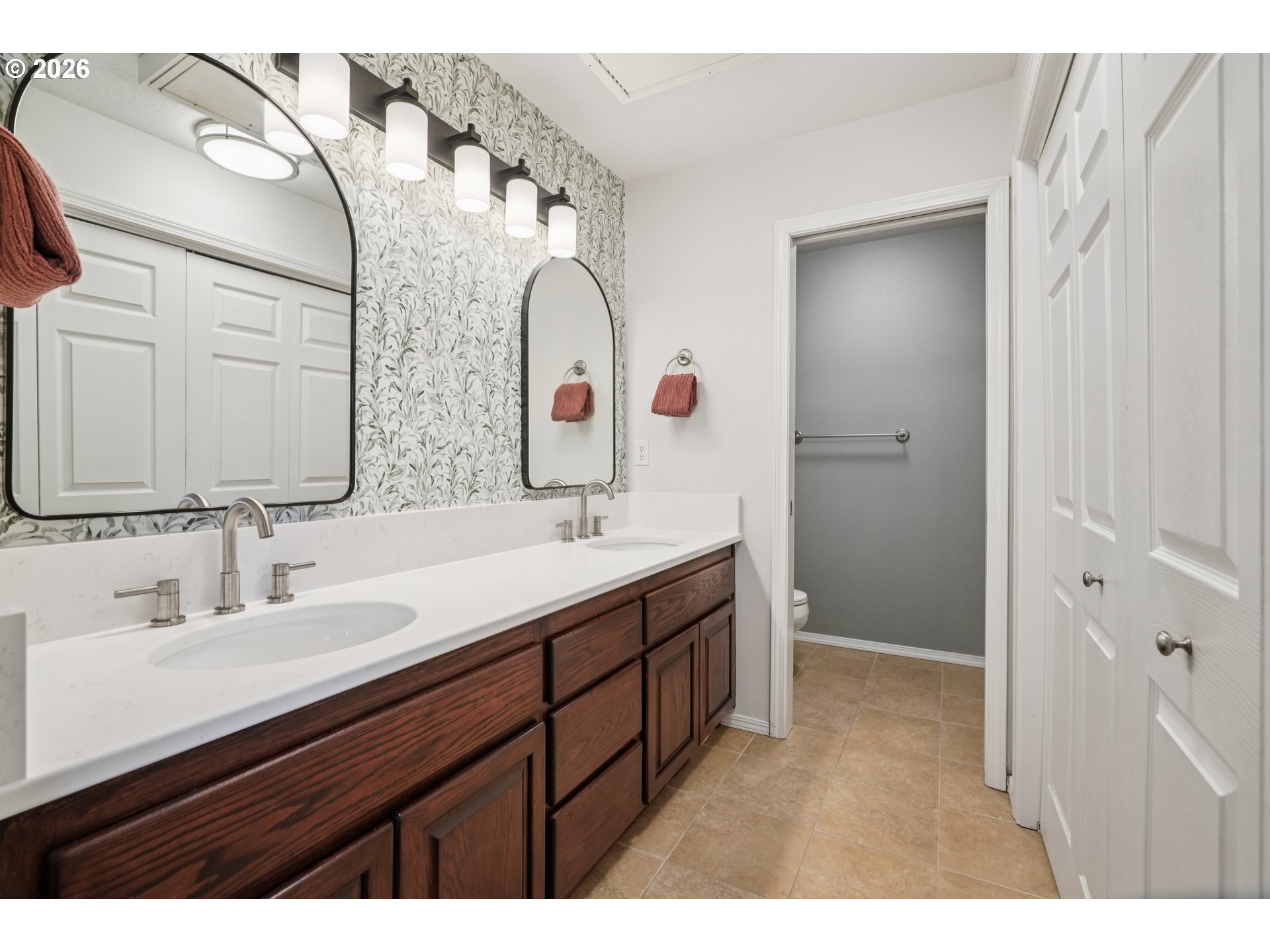 4818 Southwest 2nd Court Portland, OR 97239 - Photo 16 of 26 a bathroom with a double vanity sink and mirror