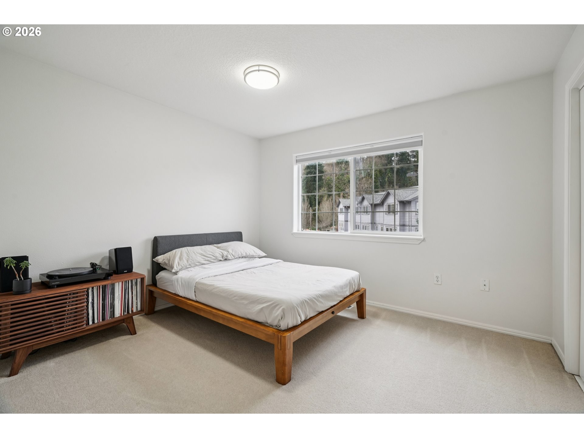 4818 Southwest 2nd Court Portland, OR 97239 - Photo 18 of 26 a bedroom with a bed and a window