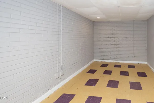 a bathroom with a black white checkered floor