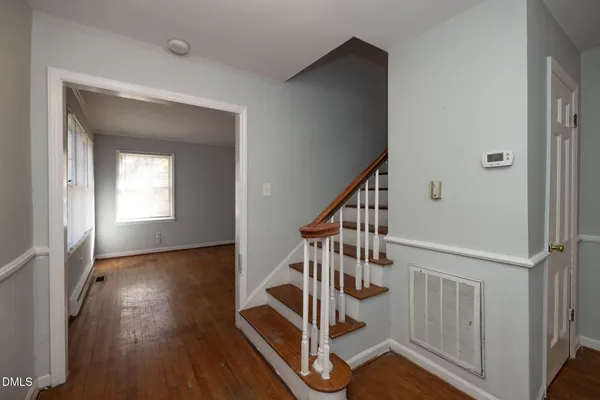 a view of entryway with wooden floor and stairs