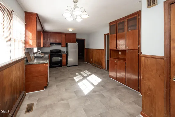a large kitchen with cabinets and stainless steel appliances