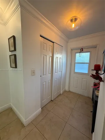 a view of an entryway with wooden floor