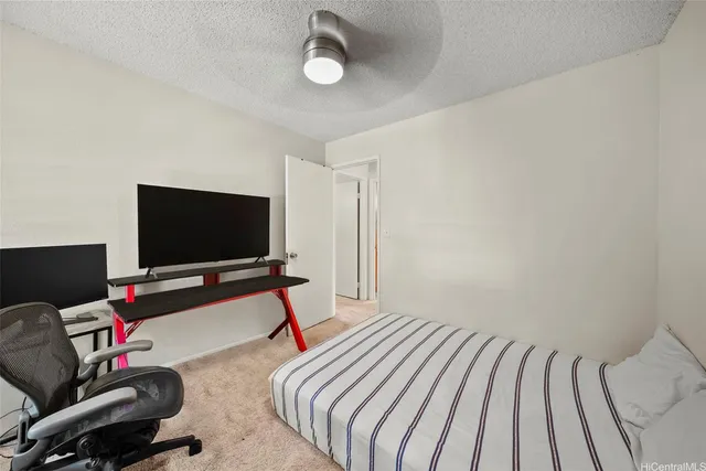 a bedroom with bed and a flat screen tv