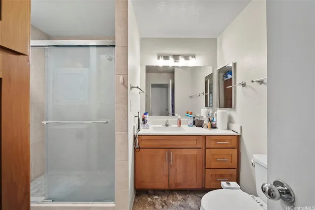 a bathroom with a sink vanity mirror and toilet