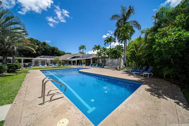 a view of swimming pool with outdoor seating and garden