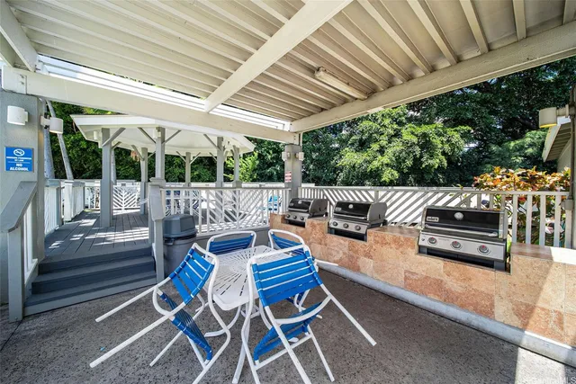 a outdoor space with patio the couches and pool table with chairs and wooden fence