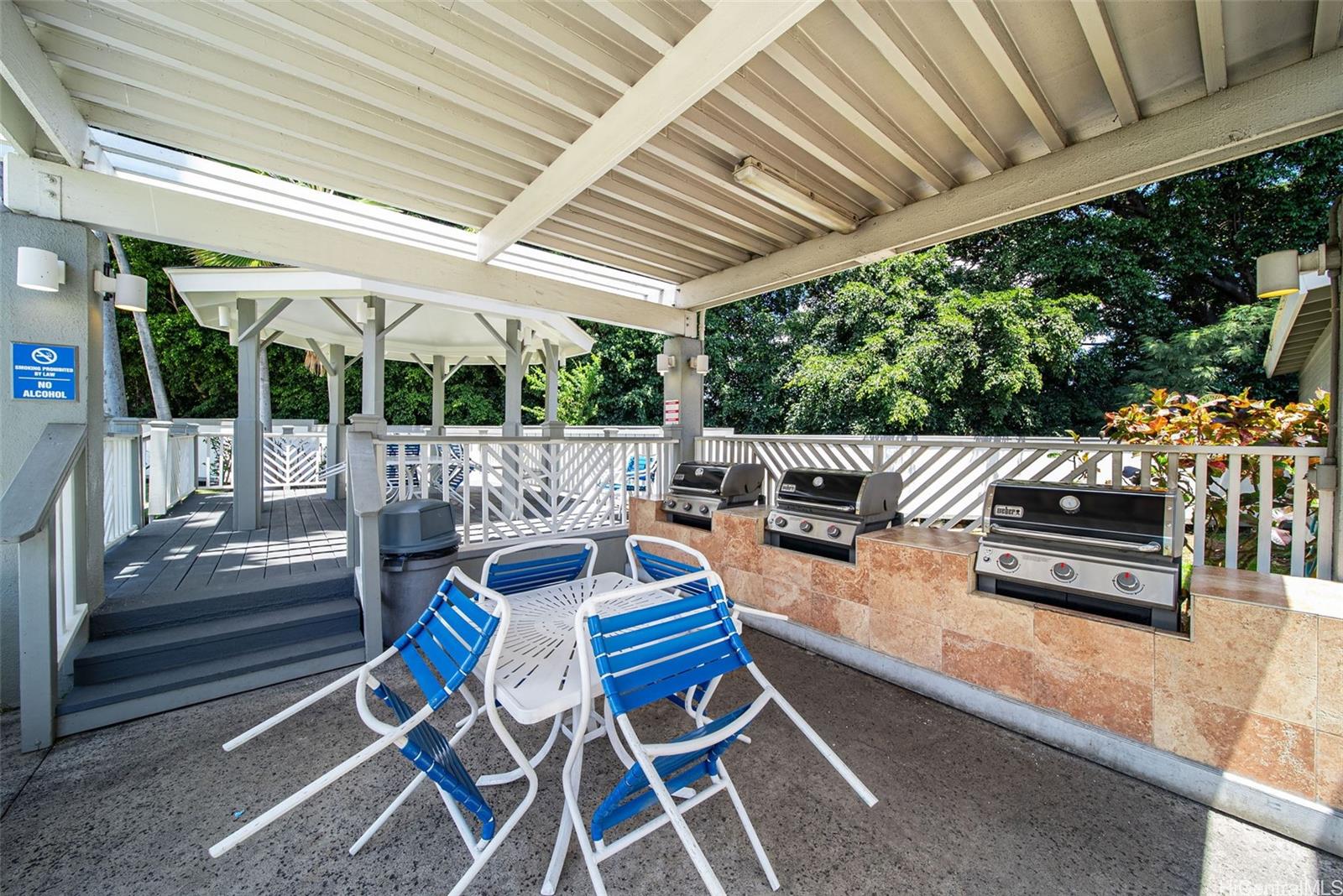429 Mananai Place, Unit 39U Honolulu, HI 96818 - Photo 21 of 23 a outdoor space with patio the couches and pool table with chairs and wooden fence