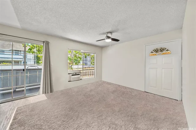 an empty room with windows and closet