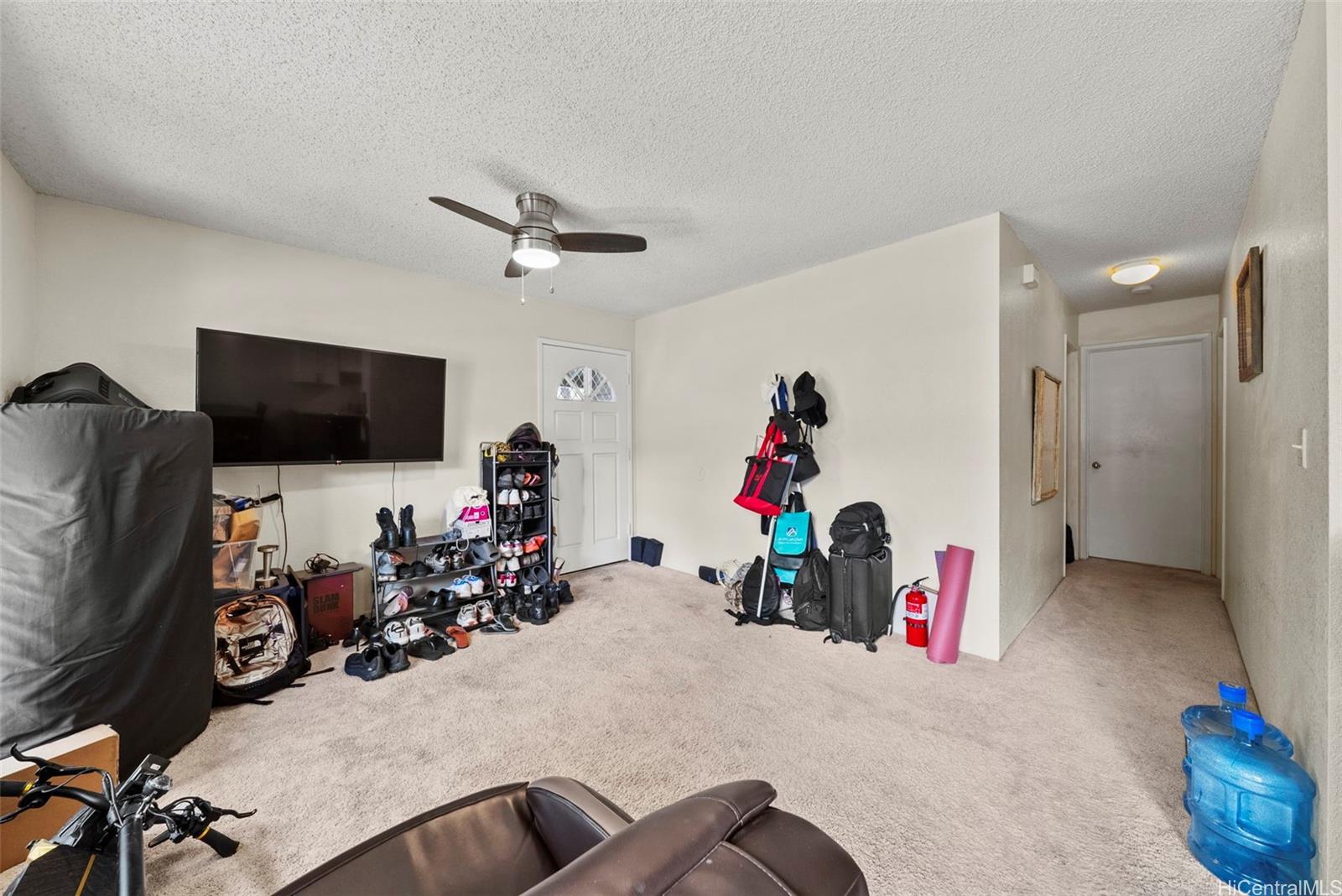 429 Mananai Place, Unit 39U Honolulu, HI 96818 - Photo 5 of 23 a view of a room with gym equipment and a flat screen tv