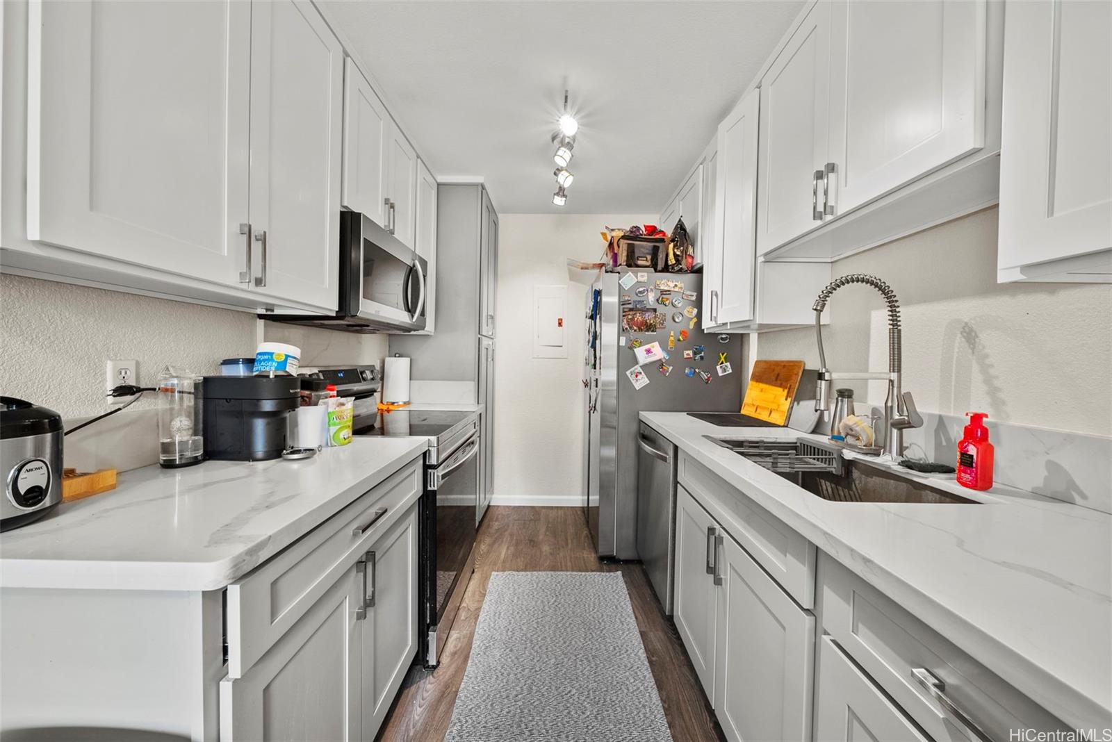 429 Mananai Place, Unit 39U Honolulu, HI 96818 - Photo 7 of 23 a kitchen with a sink dishwasher a stove and a refrigerator with wooden cabinets